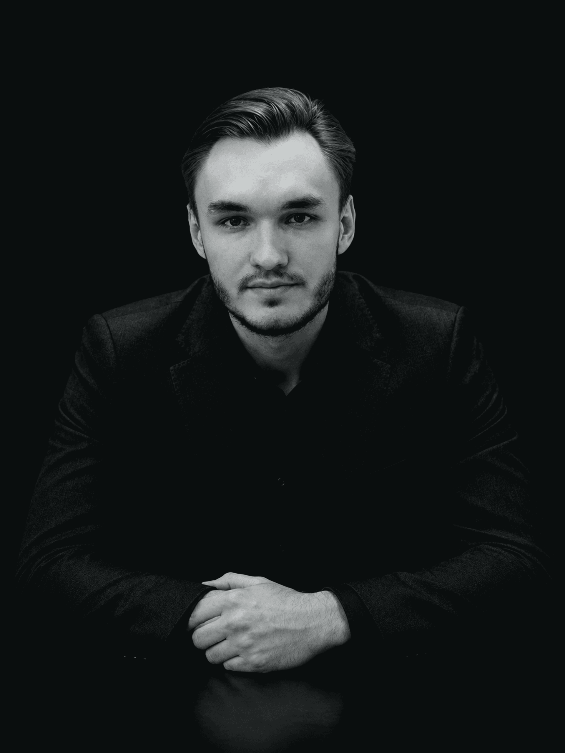 Ilia Salimov, co-founder and partner of VNSCO, in a black and white studio portrait.